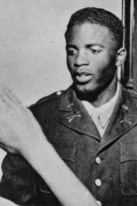 Jackie Robinson in his Army uniform is saluted by his brother Frank during a visit to his Pasadena, Calif., home in 1943.