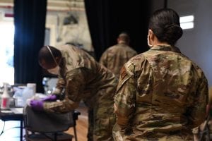 A 355th Medical Group Airman sanitizes a vaccination