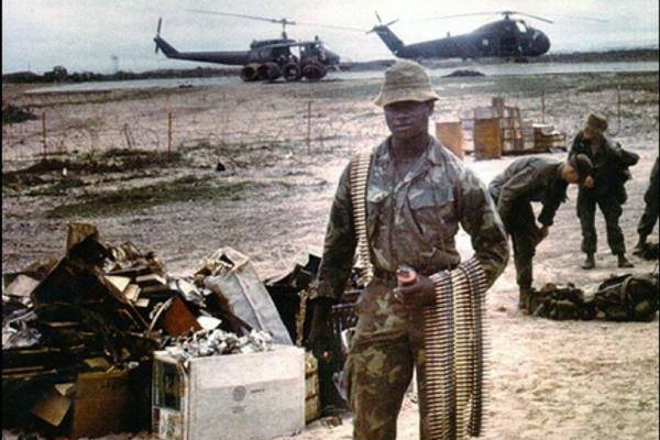 Marine Corps Private 1st Class Robert Jenkins Jr. poses with bands of ammunition during his deployment to Vietnam.