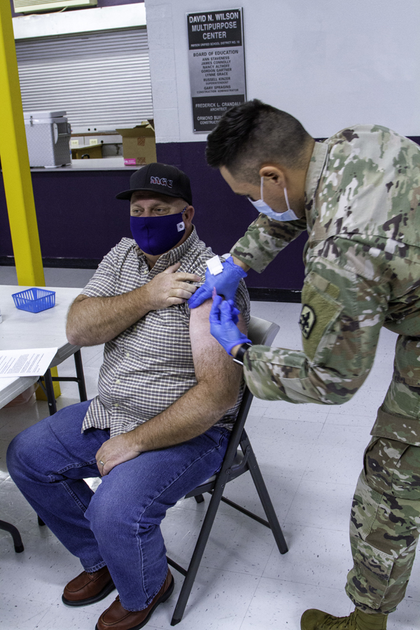Arizona Army National Guard Soldiers administer the COVID-19 vaccine to Gila County residents Feb. 1, 2021 at Payson Highschool. Guard members continue to support the state by stocking food banks, as well as distributing and administering the vaccine.