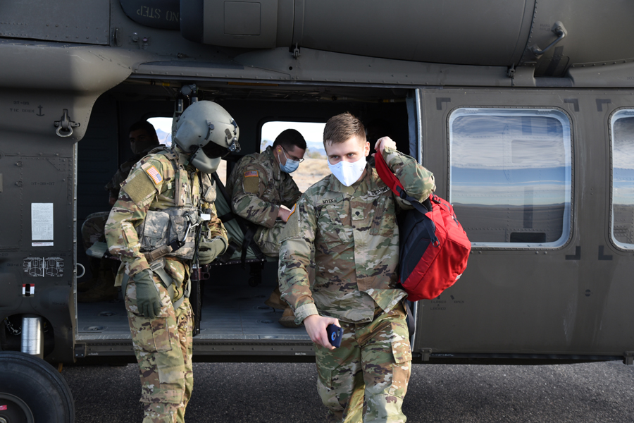 Spc. Justin Myers, 996 Area Support Medical Company, combat medic, disembarks from a UH-60 Blackhawk