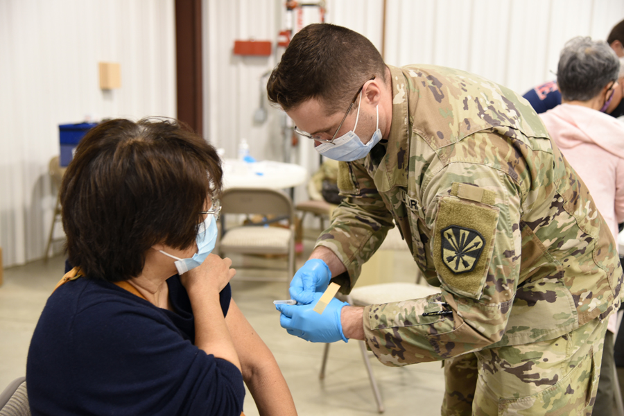 Spc. Matthew Wilcox, 996 Area Support Medical Company, combat medic, administers the COVID-19 vaccine