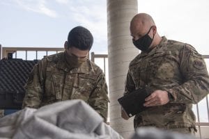 Staff Sgt. Cyrus Traulsen, 563rd Operational Support Squadron Aircrew Flight Equipment Flight craftsman, teaches Airman 1st Class Timothy Toston, 563rd OSS AFE troop, how to inspect a piece of equipment at Davis-Monthan Air Force Base