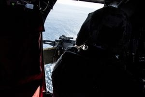 A U.S. Navy MH-60S Seahawk flies over the Pacific Ocean