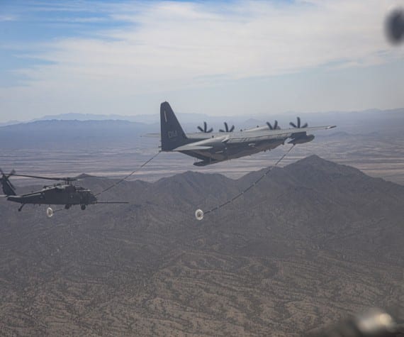 A U.S. Air Force HC-130 Hercules performs a helicopter air-to-air refueling with an HH-60 Pave Hawk at Davis-Monthan Air Force Base, Arizona, June 10, 2021. The HC-130 piloted by U.S. Air Force Maj. James Corless refueled two HH-60 Pave Hawks, one of which was piloted by his spouse, U.S. Air Force Maj. Heather Corless. (U.S. Air Force photo by Airman William Turnbull)