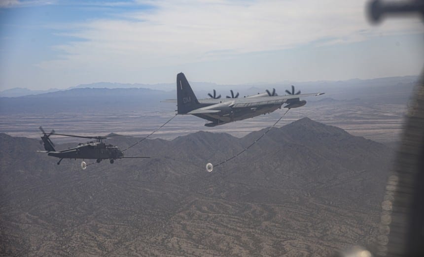 A U.S. Air Force HC-130 Hercules performs a helicopter air-to-air refueling with an HH-60 Pave Hawk at Davis-Monthan Air Force Base, Arizona, June 10, 2021. The HC-130 piloted by U.S. Air Force Maj. James Corless refueled two HH-60 Pave Hawks, one of which was piloted by his spouse, U.S. Air Force Maj. Heather Corless. (U.S. Air Force photo by Airman William Turnbull)