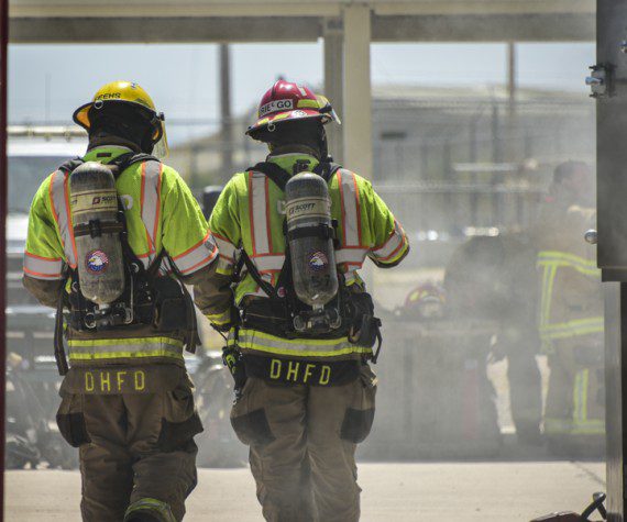 Local firefighters from the Drexel Heights Fire District take part in a simulated residential structure fire at the fire training grounds on Davis-Monthan Air Force Base, Arizona, April 13, 2022. DM has hosted 10 outside agencies and more than 400 personnel through the Regional Fire Training Center, resourcing these training grounds to complete auto extrication scenarios, live fire burns and the Emergency Vehicle Operators Course, to name a few. (U.S. Air Force photo by Senior Airman Kaitlyn Ergish)