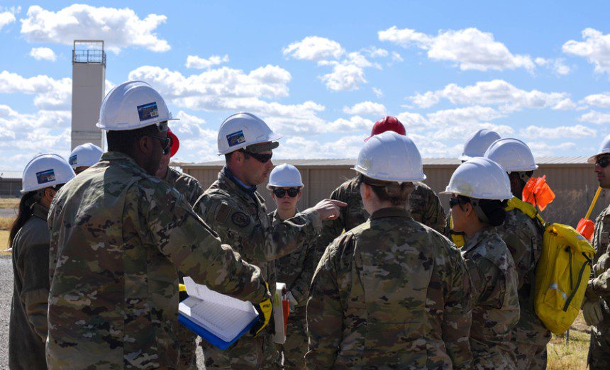 Airmen from the 355th Force Support Squadron delegate which roles they need to perform during a full-scale Major Accident Response Exercise at Davis-Monthan Air Force Base, Ariz., Feb. 17, 2022. These roles help create a walking line to search for debris and personal effects in order to mark them with flags and information cards detailing the items found. (Air Force photograph by Airman 1st Class Vaughn Weber)