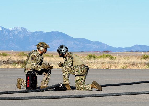 U.S. Air Force Tech. Sgt. Brian Bell, left, discusses mission operations with Master Sgt. Byron Simon, right, 79th Rescue Squadron loadmasters, during Exercise Agile Angel at Fort Huachuca, Ariz., Feb. 20, 2024. The loadmasters combined capabilities with the 355th Logistics Readiness Squadron. (U.S. Air Force photo by Staff Sgt. Abbey Rieves)