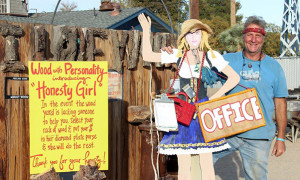 Photograph by Linda KC Reynolds U.S. Air Force veteran Timothy Hynes stands with Honesty Girl, who collects money 24/7, rain or shine, at The Ranch -- a self-help wood service that started 20 years ago when Hynes asked his Boeing coworkers if they would like to go in on a semi-truck load of wood.