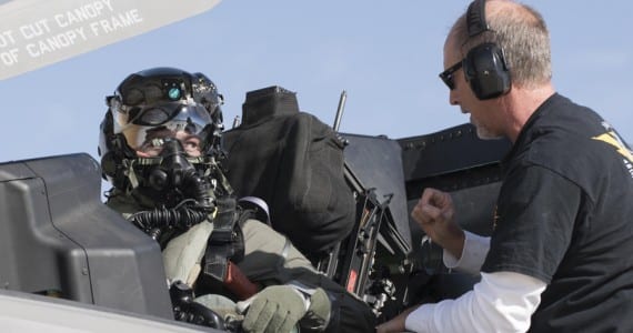 Then Marine Corps Maj. Aaron Frey, 461st Flight Test Squadron, speaks with Jim Kristo, 461st FLTS, while seated in an F-35B during tests of a chemical/biological pilot ensemble at Edwards Air Force Base, Calif. Fray passed away July 5, 2021, in a traffic accident accident near Panamint Valley, Calif. Air Force photograph by Brad White