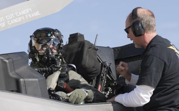 Then Marine Corps Maj. Aaron Frey, 461st Flight Test Squadron, speaks with Jim Kristo, 461st FLTS, while seated in an F-35B during tests of a chemical/biological pilot ensemble at Edwards Air Force Base, Calif. Fray passed away July 5, 2021, in a traffic accident accident near Panamint Valley, Calif. Air Force photograph by Brad White