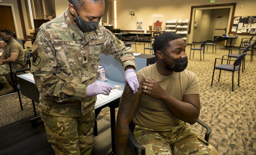 Senior Airman Rendall Powell, 412th Test Wing, receives a COVID-19 vaccination shot from Lt. Col. Yvonne Storey, 412th Medical Group, at the Airman and Family Readiness Center on Edwards Air Force Base, California, Aug. 25. Secretary of Defense Lloyd J. Austin III issued a memorandum directing mandatory COVID-19 vaccinations for service members. John F. Kirby, Pentagon press secretary, said only Food and Drug Administration-approved vaccines will be mandatory. (Air Force photo by Katherine Franco)