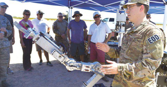 Senior Airman William Langston, 56th Civil Engineer Squadron Explosive Ordnance Disposal technician, briefs business and government leaders from the community who have been selected as honorary commanders at Luke Air Force Base on how the robot functions Aug. 31 during a tour of the Barry M. Goldwater Range, Gila Bend Air Force Auxiliary Field. The honorary commanders observed how the range is used on a daily basis to help achieve Luke’s mission to train F-35 Lightning II and F-16 Fighting Falcon pilots. Photo by Photos by Senior Airman Devante Williams