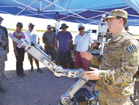 Senior Airman William Langston, 56th Civil Engineer Squadron Explosive Ordnance Disposal technician, briefs business and government leaders from the community who have been selected as honorary commanders at Luke Air Force Base on how the robot functions Aug. 31 during a tour of the Barry M. Goldwater Range, Gila Bend Air Force Auxiliary Field. The honorary commanders observed how the range is used on a daily basis to help achieve Luke’s mission to train F-35 Lightning II and F-16 Fighting Falcon pilots. Photo by Photos by Senior Airman Devante Williams