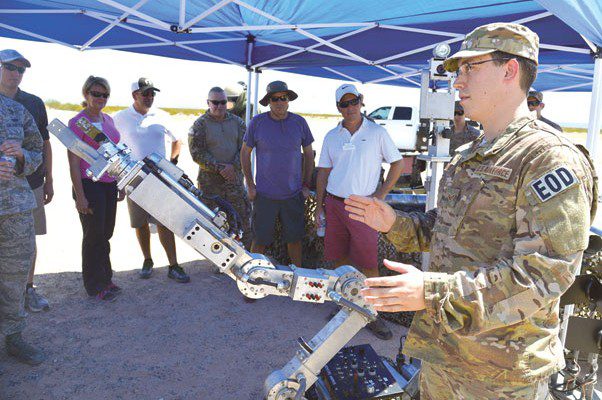 Senior Airman William Langston, 56th Civil Engineer Squadron Explosive Ordnance Disposal technician, briefs business and government leaders from the community who have been selected as honorary commanders at Luke Air Force Base on how the robot functions Aug. 31 during a tour of the Barry M. Goldwater Range, Gila Bend Air Force Auxiliary Field. The honorary commanders observed how the range is used on a daily basis to help achieve Luke’s mission to train F-35 Lightning II and F-16 Fighting Falcon pilots. Photo by Photos by Senior Airman Devante Williams