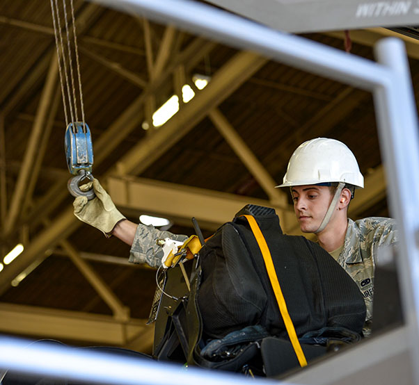 Air Force photograph by Airman 1st Class Caleb Worpel Airman 1st Class Matthew Romano, 56th Component Maintenance Squadron egress systems technician, guides a support hook to connect to an F-35A Lightning II ejection seat at Luke Air Force Base, Ariz., Jan.11, 2018. Since October 2015, pilots weighing less than 136 pounds have been restricted from flying the F-35 due to concerns of possible neck injuries resulting if pilots engaged in ejection seat procedures. In May 2017, three modifications were implemented to the F-35A ejection system allowing Air Force leaders to remove the weight limit restriction on pilots.