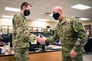 Col. James Greenwald, 944th Fighter Wing commander, congratulates Senior Airman Jed Morgan, 944th Force Support Squadron client systems technician, Jan. 31, 2021 at Luke Air Force Base, Ariz. Morgan was named the 944th FW Warrior of the Month for February 2021.