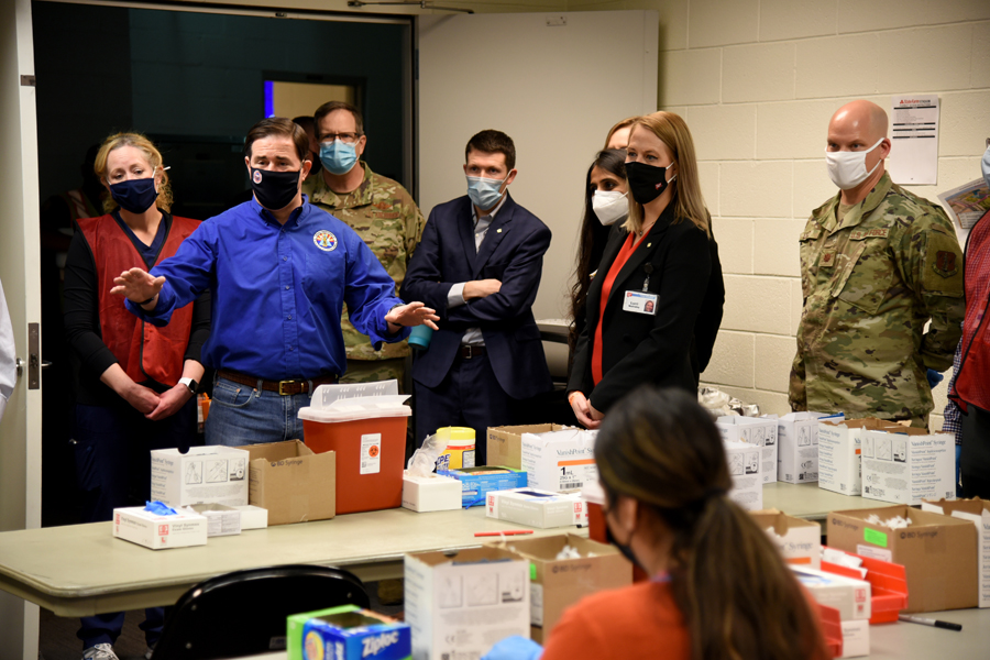 Arizona Governor Doug Ducey, Maj. Gen. Michael T. McGuire, Adjutant General for the Arizona National Guard, Dr. Cara Christ, Director of Arizona Department of Health Services, and other VIPs, visit the pharmacy, where the vaccinations are stored and syringes are filled, at a state run, Federal Emergency Management Agency supported, COVID-19 vaccination distribution facility in Glendale, Ariz., Feb. 05, 2021. The governor and VIPs also visited with National Guard soldiers, staff, and volunteers at the drive-through vaccination distribution site. (U .S. Air National Guard photo by Tech. Sgt.