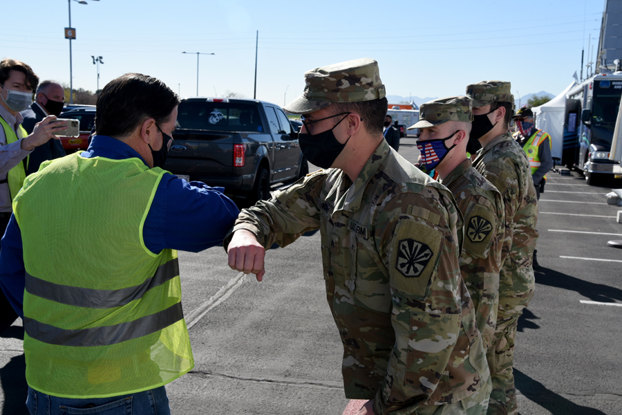Arizona Governor Doug Ducey, met with and thanked Arizona National Guard soldiers who are assisting staff and volunteers at a state run, Federal Emergency Management Agency supported, COVID-19 vaccination distribution facility in Glendale, Ariz., Feb. 05, 2021. The governor and other VIPs visited the pharmacy, where the vaccinations are stored and syringes are filled, as well as all stages of the drive-through vaccination distribution site. (U .S. Air National Guard photo by Tech. Sgt.