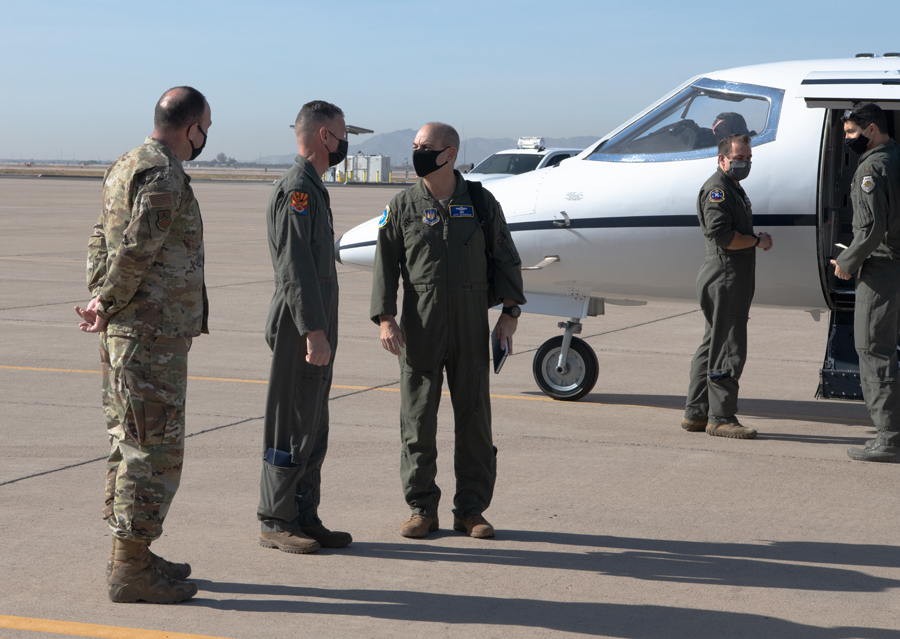 Chief Master Sgt. Daniel Weimer, left, 56th Fighter Wing command chief, and Brig. Gen. Gregory Kreuder, center, 56th FW commander, greet Gen. Jeff Harrigian