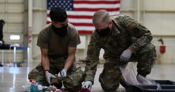 Staff Sgt. Sergio Tosi, 944th Aeromedical Staging Squadron medical technician and Senior Master Sgt. Jeffrey Neilsen, 944th ASTS medical material medic, prepare pork tracheas