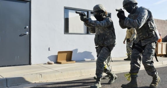 Airmen from the 56th SFS move toward a building with a simulated active shooter