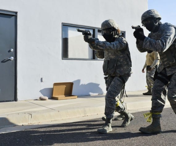 Airmen from the 56th SFS move toward a building with a simulated active shooter