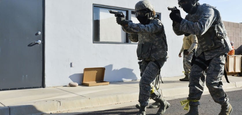 Airmen from the 56th SFS move toward a building with a simulated active shooter