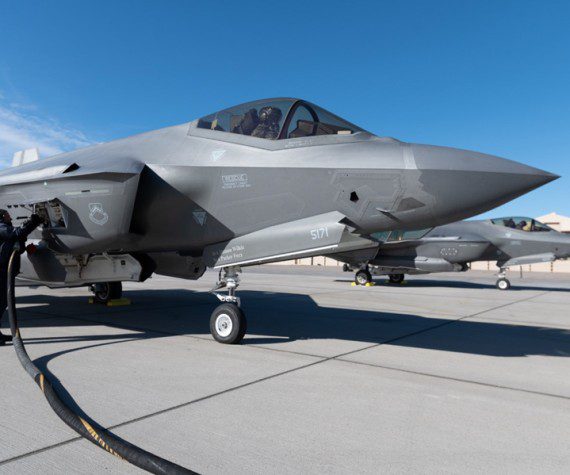 Two F-35A Lightning IIs assigned to the 63rd Fighter Squadron refuel as they pass through a forward armament refueling point (FARP) before departing from an undisclosed location Dec. 9, 2021. Student-pilots from the 63rd Fighter Squadron recently completed a mission designed to demonstrate the U.S. Air Force’s ability to quickly compose force packages from any operational environment. (Air Force photograph by Ryan Waters)