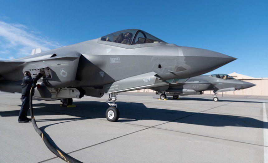 Two F-35A Lightning IIs assigned to the 63rd Fighter Squadron refuel as they pass through a forward armament refueling point (FARP) before departing from an undisclosed location Dec. 9, 2021. Student-pilots from the 63rd Fighter Squadron recently completed a mission designed to demonstrate the U.S. Air Force’s ability to quickly compose force packages from any operational environment. (Air Force photograph by Ryan Waters)