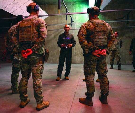 U.S. Air Force Lt. Gen. Brian S. Robinson, commander of Air Education and Training Command, learns how the 56th Security Forces Squadron is integrating the new Weapons & Tactics program into training at Luke Air Force Base, Arizona, July 21, 2022. The 56th SFS is finding ways to innovate and accelerate change by integrating new initiatives into training at Luke AFB.