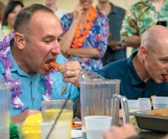 U.S. Air Force Chief Master Sgt. Daniel Weimer (left), 56th Fighter Wing command chief, competes against fellow chiefs in a wing eating contest June 24, 2022, at Luke Air Force Base, Arizona. (U.S. Air Force photos by Airman Mason Hargrove)
