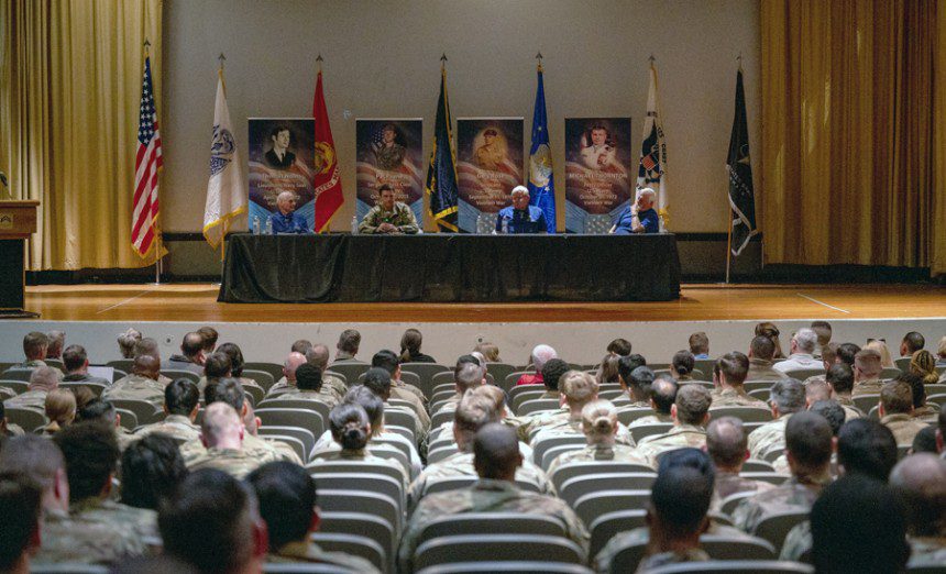 Airmen and family listen to stories from Medal of Honor recipients at a MoH panel on Feb. 10, 2023, at Luke Air Force Base, Ariz. The panel was held to give recognition to four Congressional MoH recipients through military and community engagement. From left: Thomas Norris, Pay Payne, Gary Rose and Michael Thornton.  (Air Force photograph by Senior Airman Dominic Tyler)