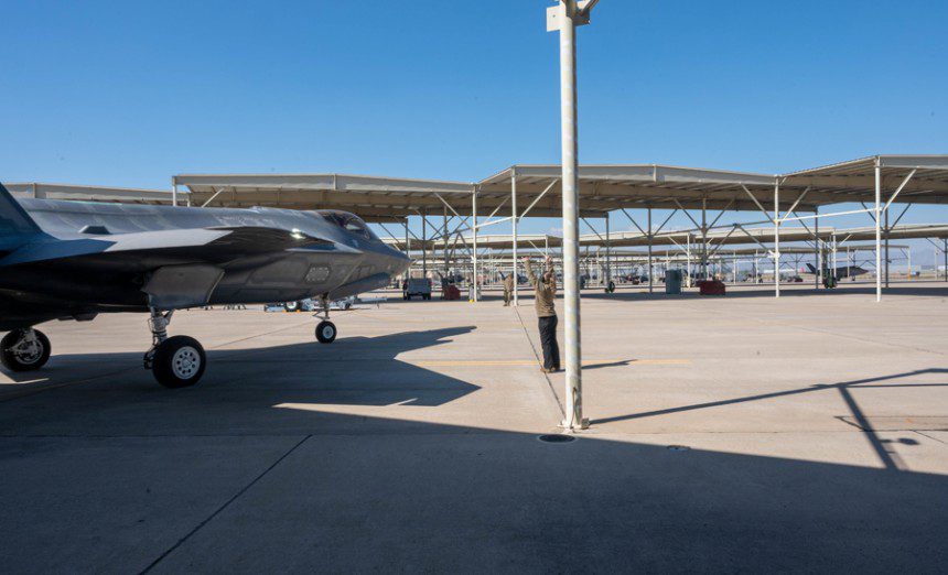U.S. Air Force Senior Airman Abigail Harris, 308th Aircraft Maintenance Unit crew chief, marshals an F-35 Lightning II, assigned to the 308th Fighter Squadron, March 3, 2023, at Luke Air Force Base, Arizona. The F-35 underwent an operations check flight, ensuring its airworthiness after maintenance was conducted. (U.S. Air Force photo by Airman 1st Class Jakob Hambright)