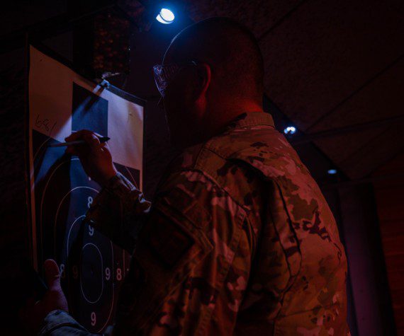 U.S. Air Force Staff Sgt. Nathan Rust, 56th Security Forces Squadron combat arms instructor, writes a score on a target, May 17, 2023, at Luke Air Force Base, Arizona. The 56th SFS held a shooting competition as one of the squadron’s events for National Police Week. Luke AFB’s combat arms instructors are responsible for ensuring every 56th SFS member is proficient and skilled in their ability to use weapons when an emergency arises. (U.S. Air Force photo by Airman 1st Class Elias Carrero)