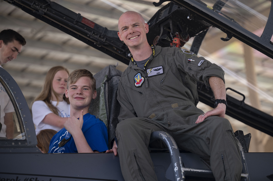 Joseph D., a child with the Make-A-Wish foundation, left, and U.S. Air Force Maj. Aaron Hieronymus, 17th Weapons Squadron weapon systems officer, are at Nellis Air Force Base, Nev., to tour the F-15E on June 2, 2023. A wish is as important as any treatment or medicine, a wish is a prescription for hope. The Make-A-Wish Foundation is a nonprofit that fulfills the wishes of children with a critical illness between the ages of 2 ½ and 18. (Air Force photograph by Senior Airman Zachary Rufus)