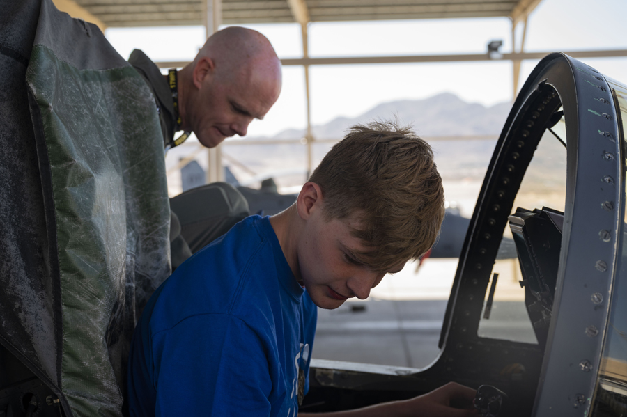 Joseph D., a child with the Make-A-Wish foundation, sits inside the cockpit of an F-15E Strike Eagle during his visit to Nellis Air Force Base, Nev., June 2, 2023. (Air Force photograph by Senior Airman Zachary Rufus)
