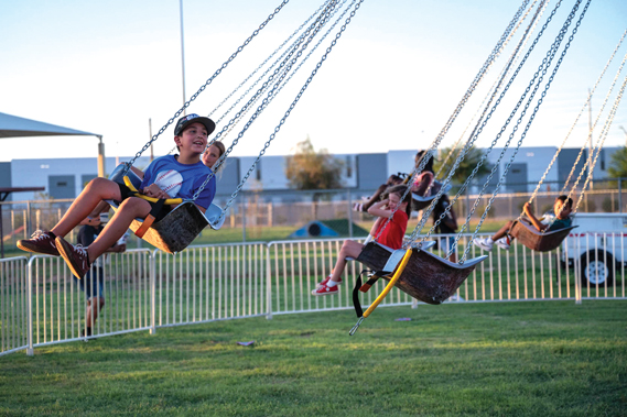 Luke Air Force Base children enjoy a carnival ride during the 2024 Freedom Fest, July 3, 2024, at Luke AFB, Arizona. Freedom Fest allowed Luke AFB community members to come together and celebrate the upcoming fourth of July holiday. (U.S. Air Force photo by Senior Airman Jakob Hambright)