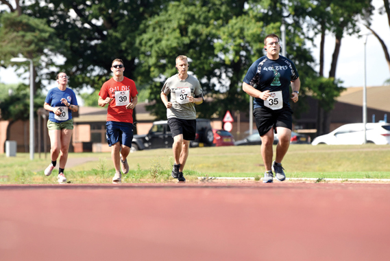 Liberty Wing Airmen participate in Operation Warm Heart run-a-thon at Royal Air Force Lakehnheath, England, August 2, 2019. For each lap completed during the event, the runner's sponsors donated money to OWH which provides emergency funds for Airmen in difficult situations. (U.S. Air Force photo by Airman 1st Class Madeline Herzog)