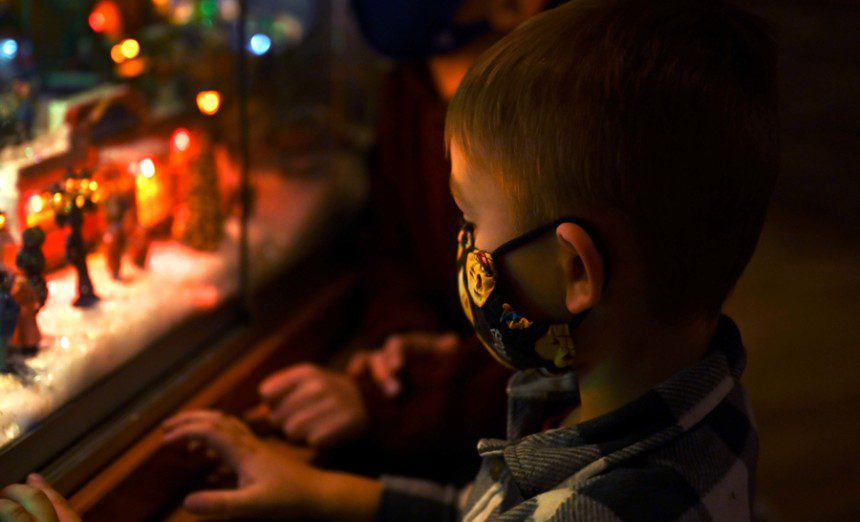 A child looks at a holiday village display inside the Nellis Club at Nellis Air Force Base, Nevada, Dec. 3, 2021. The Nellis Club held the Frost Fest which included photos with Santa Clause and Mrs. Clause, refreshments and a wine-tasting event. (U.S. Air Force Photo by Staff Sgt. Gabriela Keiser)