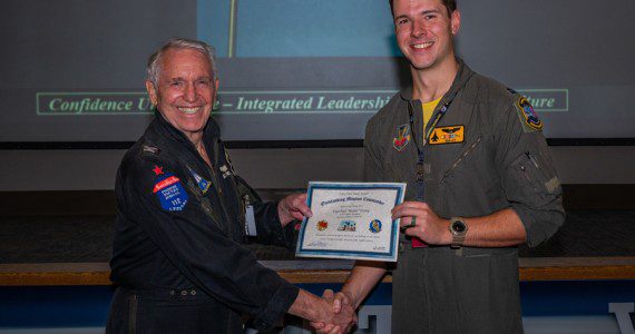 Capt. Paul Young, a pilot assigned to the 336th Fighter Squadron, Seymour Johnson, N.C., accepts the Capt. John Stone award for ‘Outstanding Mission Commander’ by its namesake, retired Col. John “JB” Stone, during the Red Flag-Nellis 22-3 culmination ceremony at Nellis Air Force Base, Nev., July 28, 2022. The Capt. John Stone award is the mark of influential and quintessential planning that will lead the Air Force into surpassing its near-peer challengers. (Air Force photograph by Airman 1st Class Josey Blades)