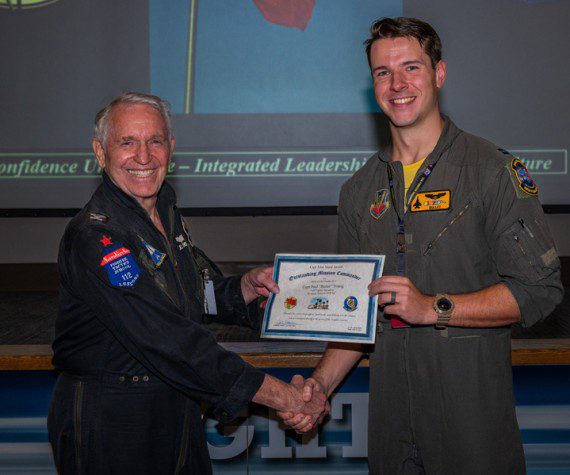Capt. Paul Young, a pilot assigned to the 336th Fighter Squadron, Seymour Johnson, N.C., accepts the Capt. John Stone award for ‘Outstanding Mission Commander’ by its namesake, retired Col. John “JB” Stone, during the Red Flag-Nellis 22-3 culmination ceremony at Nellis Air Force Base, Nev., July 28, 2022. The Capt. John Stone award is the mark of influential and quintessential planning that will lead the Air Force into surpassing its near-peer challengers. (Air Force photograph by Airman 1st Class Josey Blades)