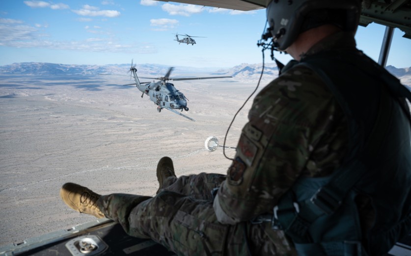 U.S. Air Force Master Sgt. David Williams a loadmaster assigned to the 102nd Rescue Squadron, New York Air National Guard, watches as two HH-60G Pave Hawks engage in refueling operations during Red Flag-Nellis 23-2 at Nellis Air Force Base, Nevada, March 16, 2023. The 102nd RQS is one of 21 units from across the coalition core function forces participating in Red Flag 23-2. (U.S. Air Force photo by Airman 1st Class Jordan McCoy)