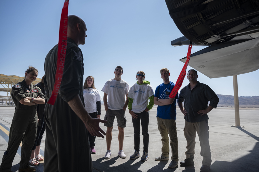 Maj. Aaron Hieronymus, 17th Weapons Squadron weapon systems officer, tells Joseph D. and his family about the F-15E Strike Eagle’s capabilities at Nellis Air Force Base, Nev., June 2, 2023. (Air Force photograph by Senior Airman Zachary Rufus)