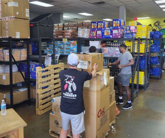 Airmen assigned to the 867th Attack Squadron, Creech Air Force Base, Nev., organize donated supplies during their volunteer efforts at Project 150, Las Vegas, Nev. The Airmen volunteered to ensure much-needed school supplies were distributed correctly and swiftly to those in need.