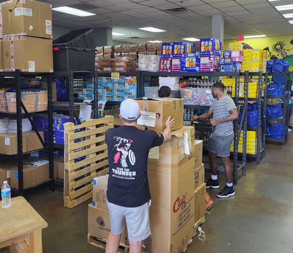 Airmen assigned to the 867th Attack Squadron, Creech Air Force Base, Nev., organize donated supplies during their volunteer efforts at Project 150, Las Vegas, Nev. The Airmen volunteered to ensure much-needed school supplies were distributed correctly and swiftly to those in need.