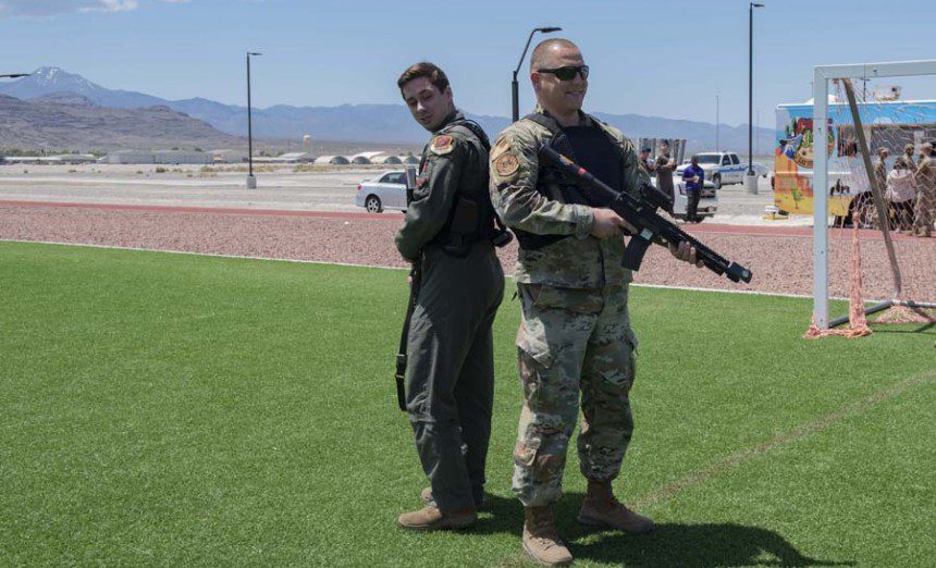Two U.S. Air Force Airmen from the 432nd Wing/432nd Air Expeditionary Wing learn how to use the StressVesto during a Police Fair, Creech Air Force Base, Nev., May 10, 2023.The Police Fair showcased various aspects of the security forces career field to Airmen and their families, offering insight into their vital role in the Air Force mission. (Air Force photograph by Airman 1st Class Victoria Nuzzi)