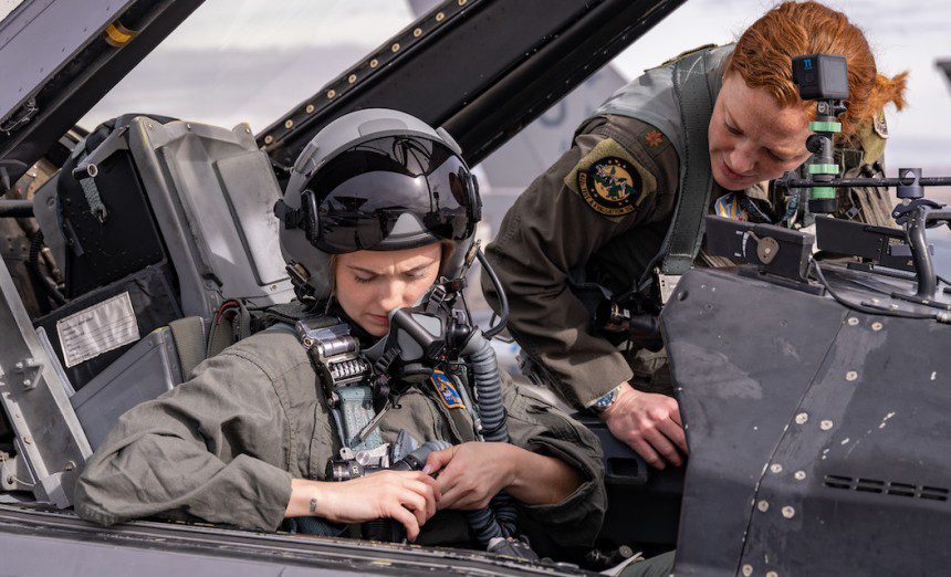 U.S. Air Force 2nd Lt. Madison Marsh buckles in for her familiarization flight at Nellis Air Force Base, Nev., Dec. 19, 2023. Marsh is a 2023 U.S. Air Force Academy graduate, and she won the title of Miss America Jan. 14, 2024, making her the first active-duty Air Force officer to win the Miss America pageant. (U.S. Air Force photo by William R. Lewis)