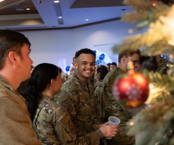 U.S. Air Force Airmen grab water during a Chief Master Sgt. select party in the Nellis Club at Nellis Air Force Base, Nevada, Dec. 7, 2023. This ceremony welcomes the new Chief Master Sgt. selects to step up and reach highest tier of the enlisted leadership structure. (U.S. Air Force photo by Airman 1st Class Timothy Perish)